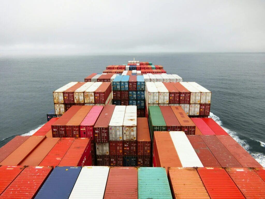 Container ship loaded with cargo containers — illustrative of China's PV export trade flow affected by the 2026 VAT rebate removal